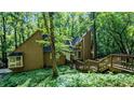 Beautiful home exterior with unique architectural design and inviting entry, surrounded by natural landscaping and tall trees at 3246 Able Ct, Marietta, GA 30062