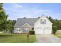 Classic two-story home with a two-car garage and beautiful front lawn, radiating suburban charm at 3971 Canebrake Ln, Douglasville, GA 30134