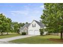 Two-story home featuring a two-car garage and a well-manicured lawn, nestled in a serene neighborhood at 3971 Canebrake Ln, Douglasville, GA 30134