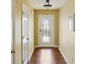 Well-lit hallway with wood flooring and a decorative front door, creating a welcoming entrance at 3971 Canebrake Ln, Douglasville, GA 30134