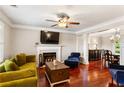 Bright living room with fireplace, hardwood floors, ceiling fan, and an abundance of natural light at 4108 Berryhill Se Trce, Smyrna, GA 30082