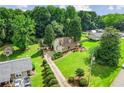 Expansive property with mature trees, long driveway, and well-manicured lawn around a charming stone home at 150 Wilbanks St, Buford, GA 30518