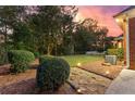 Lush backyard featuring manicured lawn, mature landscaping, and a stone walkway at 248 Montrose Dr, Mcdonough, GA 30253