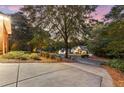 Exterior view of home with lush landscaping, mature trees, and inviting circular driveway at 248 Montrose Dr, Mcdonough, GA 30253