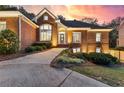 Charming brick home with meticulously landscaped front yard and inviting entrance at twilight at 248 Montrose Dr, Mcdonough, GA 30253