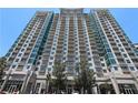 Apartment building with multiple stories and balconies, complimented by trees and ground-level retail spaces at 250 Pharr Ne Rd # 208, Atlanta, GA 30305