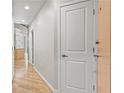 Bright hallway with hardwood floors and white doors leading to various rooms in the house at 250 Pharr Ne Rd # 208, Atlanta, GA 30305