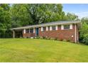 Beautiful brick home with a sloping front lawn and fresh landscaping at 2521 Whites Mill Ln, Decatur, GA 30032