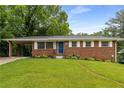 Traditional brick home with green lawn and tidy landscaping at 2521 Whites Mill Ln, Decatur, GA 30032