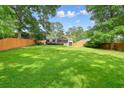 Expansive backyard with a lush lawn, mature trees, and a deck perfect for outdoor entertaining at 3734 Powers Ferry Nw Rd, Atlanta, GA 30342