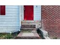 Close-up of the house's red front door and brick and siding exterior at 5415 Twin Lakes Dr, Atlanta, GA 30349