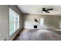 Spacious living room with fireplace, ceiling fan, and large windows providing natural light at 5415 Twin Lakes Dr, Atlanta, GA 30349