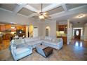 Open-concept living room featuring coffered ceilings and seamless flow to the kitchen at 6529 Terraglen Way, Locust Grove, GA 30248