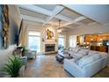 Spacious living room with fireplace, open to kitchen, and lots of natural light at 6529 Terraglen Way, Locust Grove, GA 30248