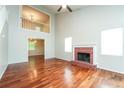 Spacious living room with hardwood floors, fireplace, abundant natural light and an open staircase at 4400 Old Allgood Cir, Stone Mountain, GA 30083