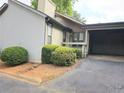 Side view of home exterior featuring an attached carport, neutral paint, and green foliage at 5025 Highland Club Dr, Marietta, GA 30068