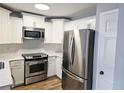 Bright kitchen with white cabinets, stainless steel appliances, and subway tile backsplash at 5025 Highland Club Dr, Marietta, GA 30068