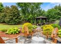 A cozy backyard with outdoor seating, a fire pit, and a charming gazebo at 1045 Fords Crossing Nw Dr, Acworth, GA 30101
