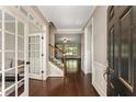 Inviting home foyer with hardwood floors, white wainscoting, and a staircase at 1045 Fords Crossing Nw Dr, Acworth, GA 30101