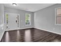 Bright entryway featuring hardwood floors, a classic front door, and elegant trim details at 581 Collingsworth Ln, Lawrenceville, GA 30043