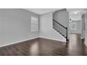 Spacious living room with hardwood floors, staircase, and modern gray paint at 581 Collingsworth Ln, Lawrenceville, GA 30043