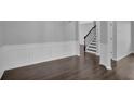 Inviting living room featuring hardwood floors and elegant wainscoting at 581 Collingsworth Ln, Lawrenceville, GA 30043