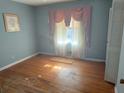 Cozy bedroom with hardwood floors, window and built in closet awaits personal touches at 1275 Bell Ave, Atlanta, GA 30344