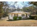 Ranch-style home with a well-kept lawn, mature trees, a ramp and classic white siding with black shutters at 272 Old Sudie Rd, Hiram, GA 30141