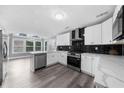 Modern kitchen featuring white cabinets, sleek countertops, stainless steel appliances and a backsplash at 4605 Tims Pl, Snellville, GA 30039