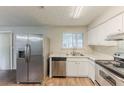 Well-lit kitchen featuring stainless steel appliances and hardwood floors at 6715 Kimberly Mill Rd, Atlanta, GA 30349