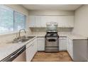 Bright kitchen with stainless steel appliances, white cabinets, and a double sink at 6715 Kimberly Mill Rd, Atlanta, GA 30349