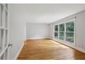 Sunlit living room with hardwood floors and large windows overlooking greenery at 1719 Woodcliff Ne Ct, Atlanta, GA 30329