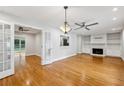 Spacious living room featuring hardwood floors, a ceiling fan, fireplace and built-in shelves at 1719 Woodcliff Ne Ct, Atlanta, GA 30329