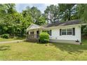 A charming one-story house featuring a covered porch and black shuttered windows at 354 Henry Aaron Sw Ave, Atlanta, GA 30310