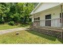 Inviting home exterior featuring a cozy front porch with wooden railings and a green lawn at 354 Henry Aaron Sw Ave, Atlanta, GA 30310