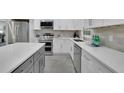 Updated kitchen with stainless appliances, white cabinets, stone countertops and island with bar stool seating at 5400 Mill Run Dr, Marietta, GA 30068