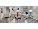 Bright living room featuring a comfortable sofa, an accent chair, and large windows with natural light at 5400 Mill Run Dr, Marietta, GA 30068