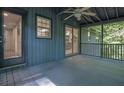 An inviting screened-in back porch featuring a ceiling fan and a view of the surrounding trees at 5400 Mill Run Dr, Marietta, GA 30068