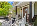 Cozy front porch with stylish seating, decorative railings, and a craftsman-style front door at 1734 8Th St, Brookhaven, GA 30341