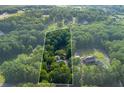 Aerial view of a secluded property surrounded by mature trees, providing privacy and a serene setting at 2024 Lower Burris Road Rd, Canton, GA 30114