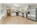Modern kitchen featuring stainless steel appliances, granite countertops, and ample storage with sleek white cabinetry at 2041 Kramer Way, Marietta, GA 30062