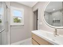 Contemporary bathroom featuring a sleek vanity, round mirror, and glass-enclosed shower with marble tile at 2872 Estuary Dr, Acworth, GA 30101