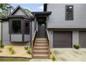 Home exterior featuring a gabled facade, front porch stairs, bay window, and a two-car garage at 2872 Estuary Dr, Acworth, GA 30101
