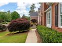 A well-manicured lawn and vibrant landscaping accent the brick home's exterior at 3361 Woodington Se Ct, Marietta, GA 30067