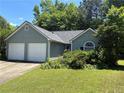 Attractive one-story house with a two-car garage, lush lawn, and mature trees at 4302 Orange Court Nw Ct, Acworth, GA 30101