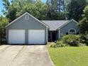 Inviting one-story house with a two-car garage, dark roof, and well-maintained front yard at 4302 Orange Court Nw Ct, Acworth, GA 30101