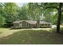 Ranch home featuring traditional styling, well-maintained landscaping and a symmetrical design at 5807 Christopher Ln, Lithonia, GA 30058