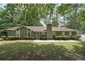 Ranch home featuring traditional styling, well-maintained landscaping and a symmetrical design at 5807 Christopher Ln, Lithonia, GA 30058