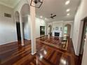 Elegant living room with hardwood floors, fireplace, and arched doorways at 2504 Dalesford Ct, Dacula, GA 30019