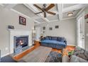 Inviting living room featuring a cozy fireplace, coffered ceilings, hardwood floors, and natural light at 2677 Sardis Chase Ct, Buford, GA 30519